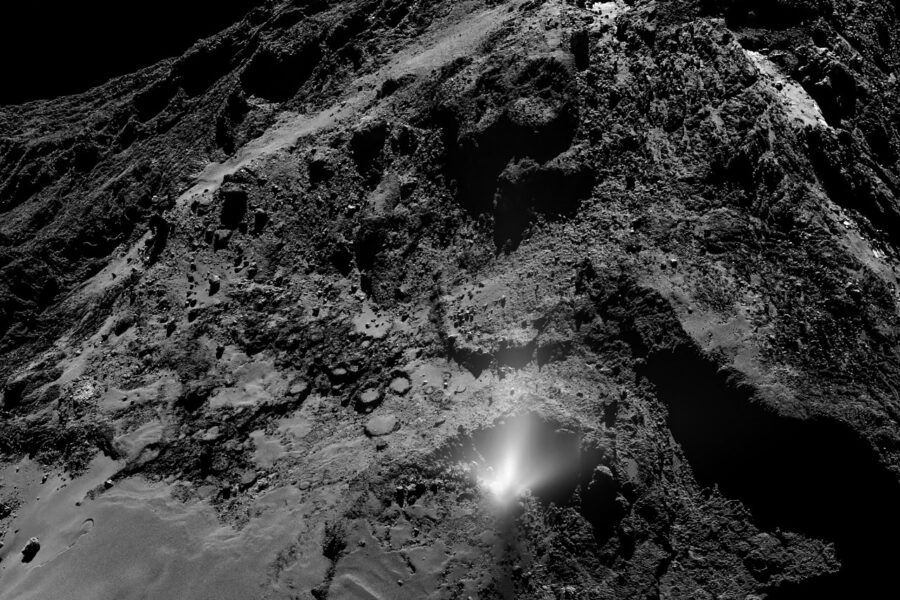 real photo of a plume of dust and gas erupting from the nucleus of a comet